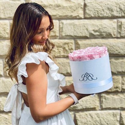 Large Round Infinity Rose Box - Model holding white rose box with pink roses